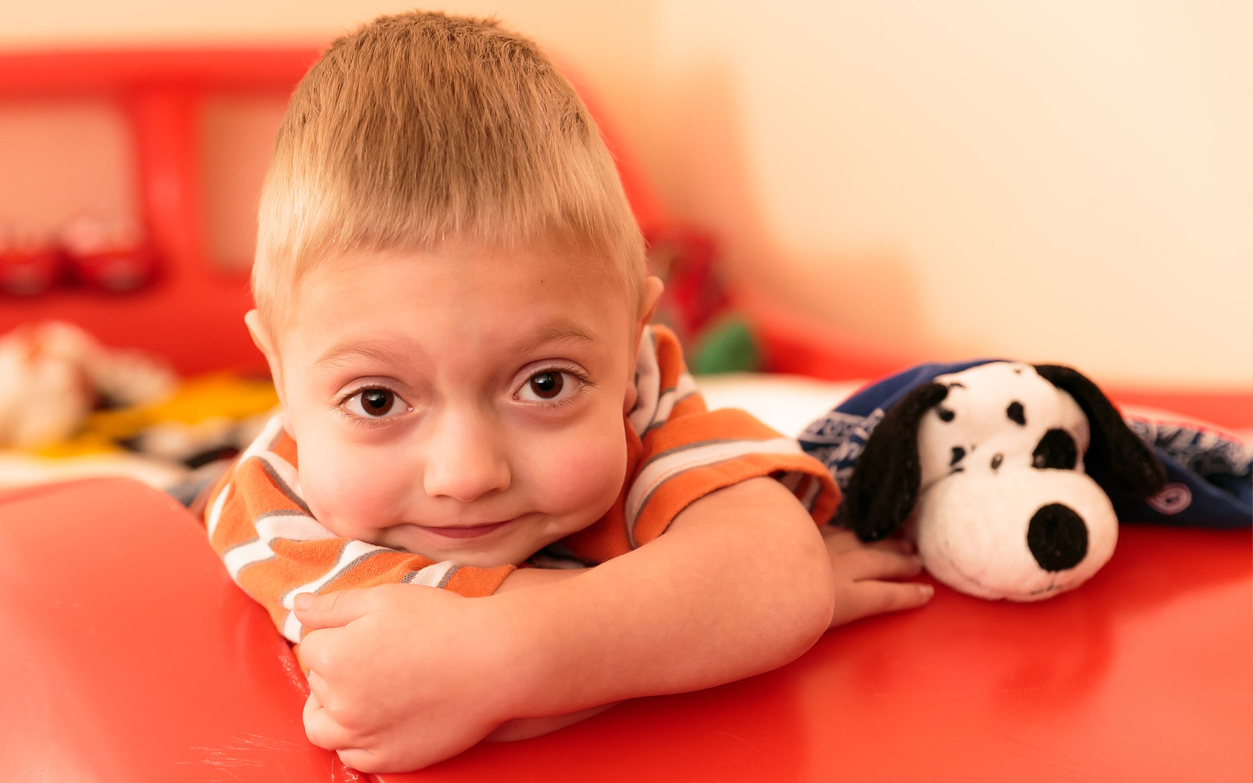 Tanner, diagnosed with HPP at 4 days old, with a stuffed animal